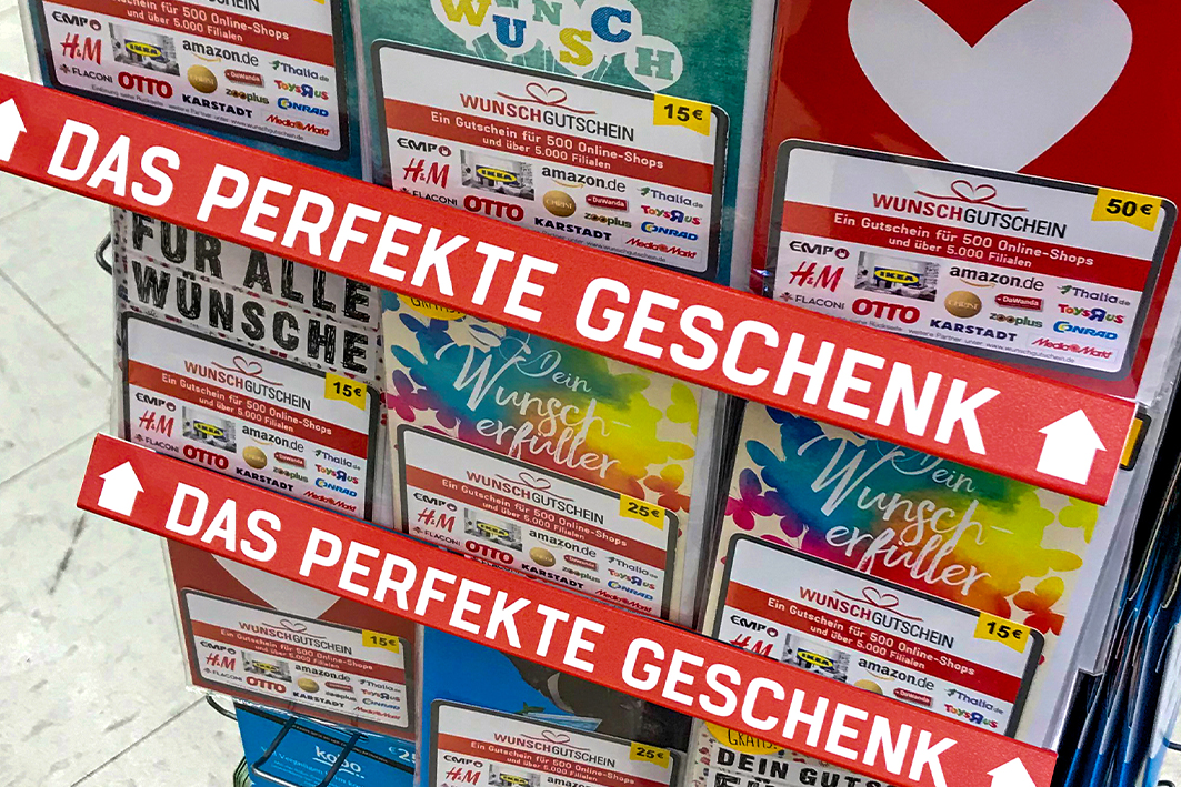 A newspaper stand with german magazines displayed