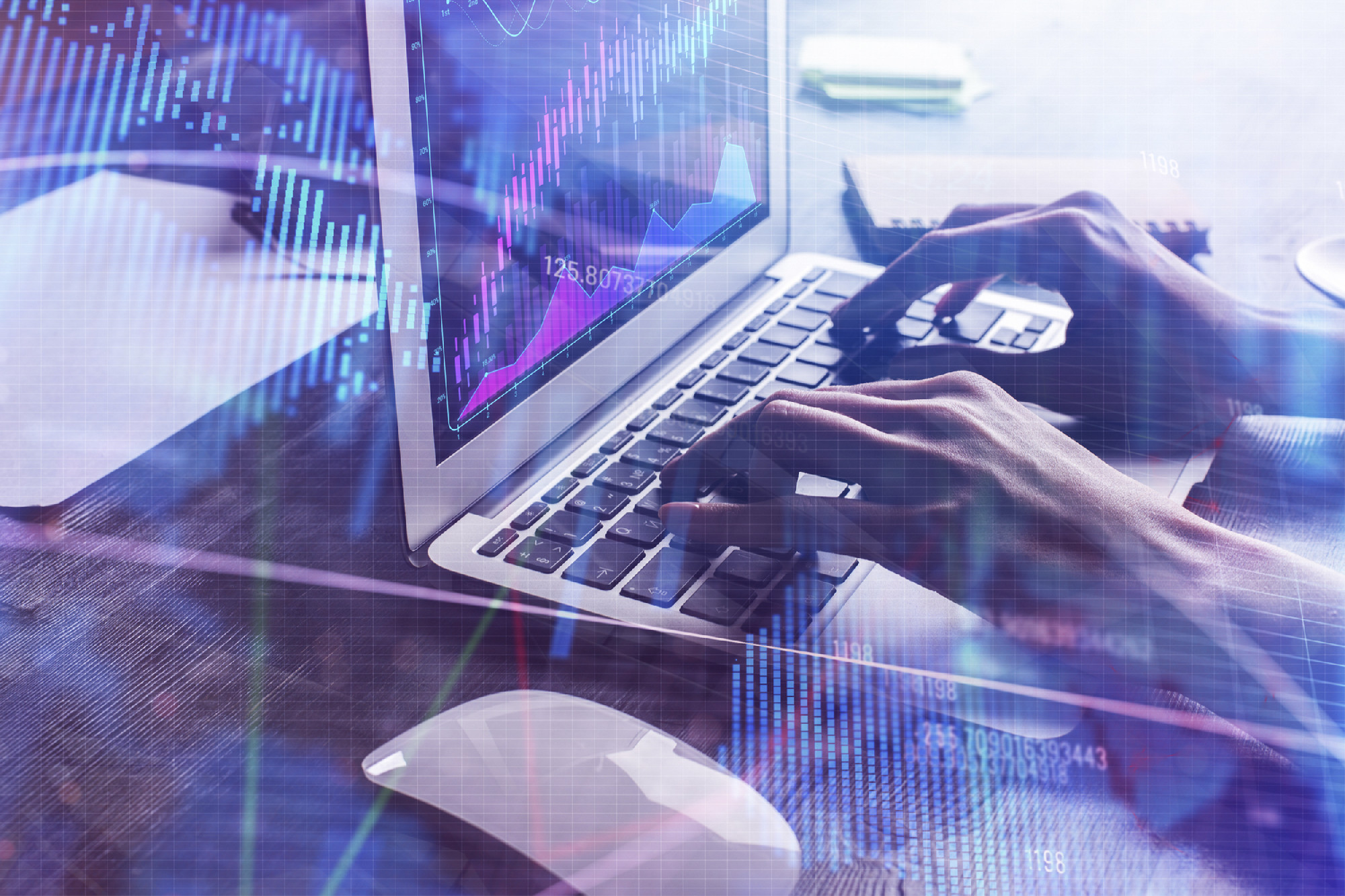 Hands using laptop with forex chart placed on office desk with other items. Accounting, finance and stock concept. Double exposure