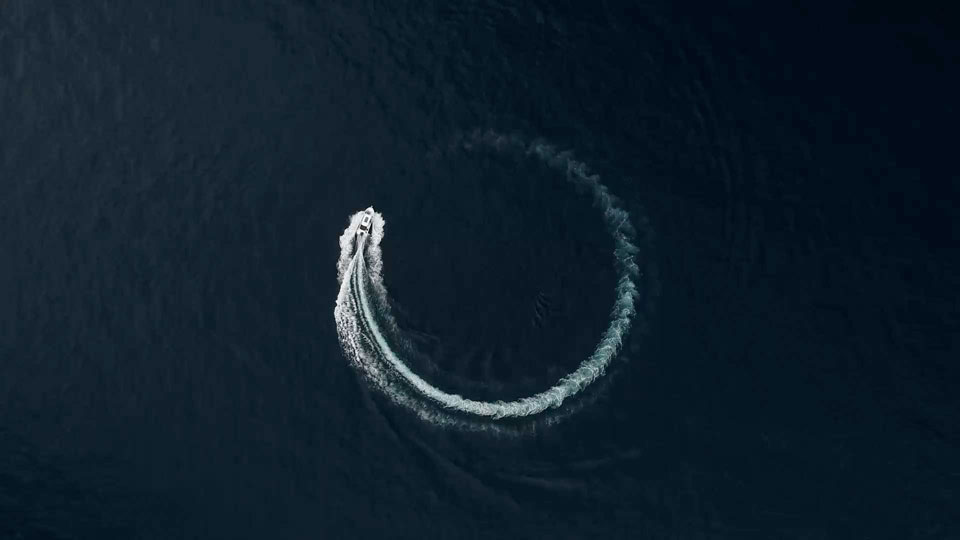 Boat moving in a circle leaving a foam trail behind