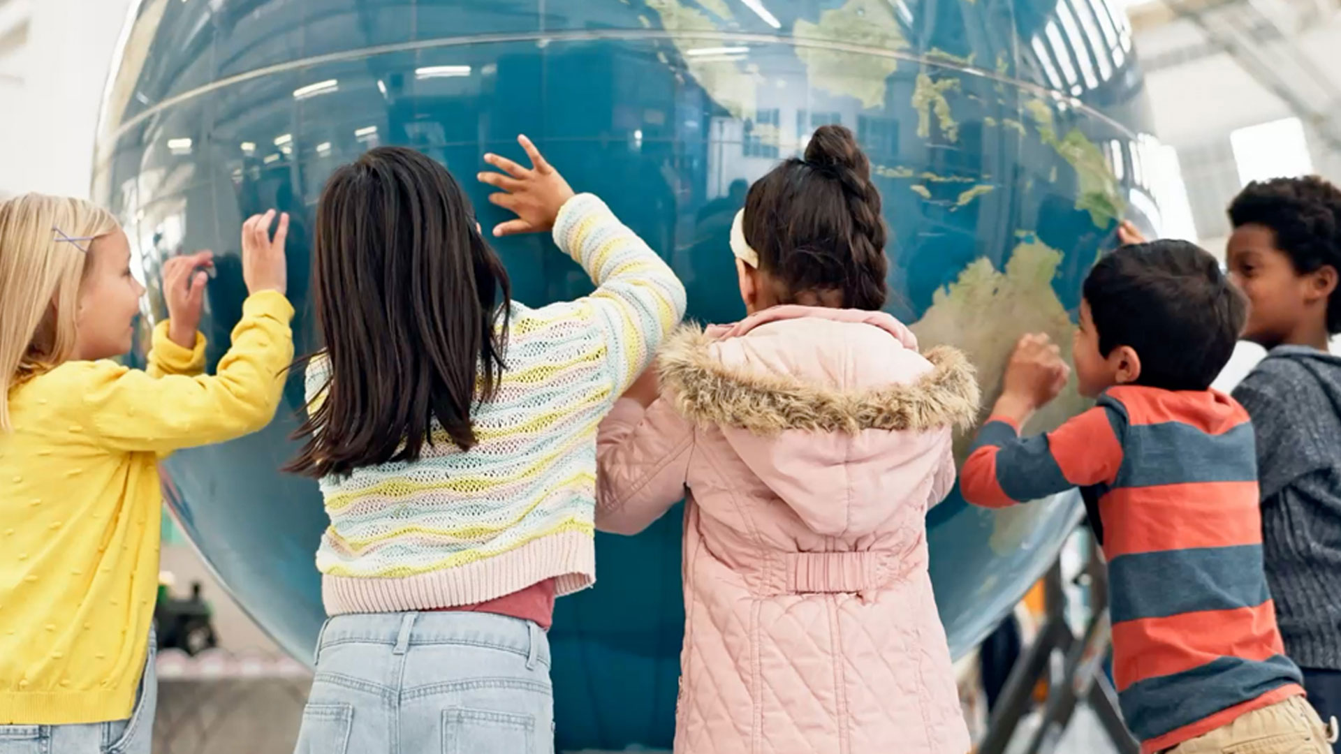 World, map and children learning with a globe in classroom