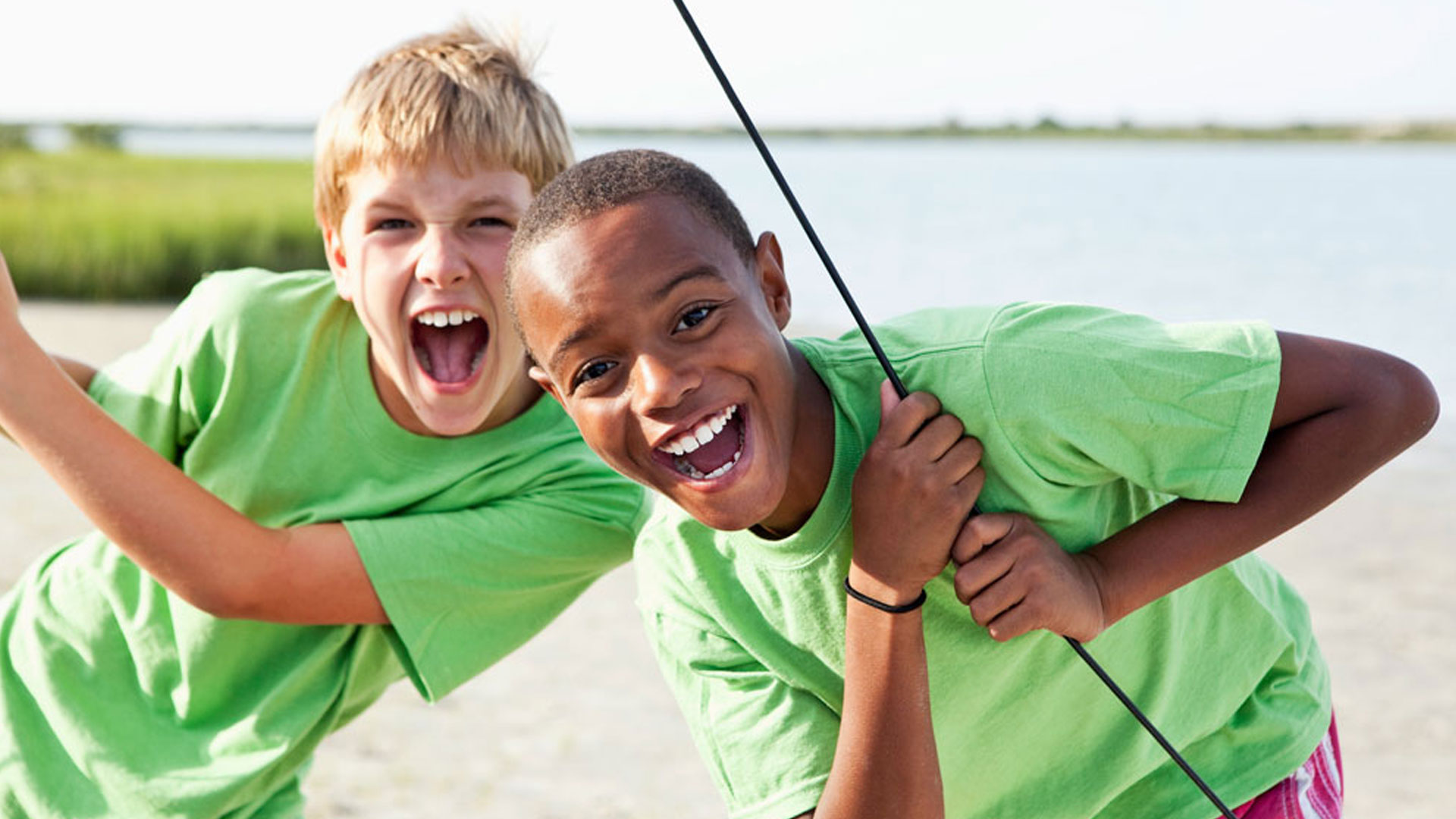 Boys standing on catamaran