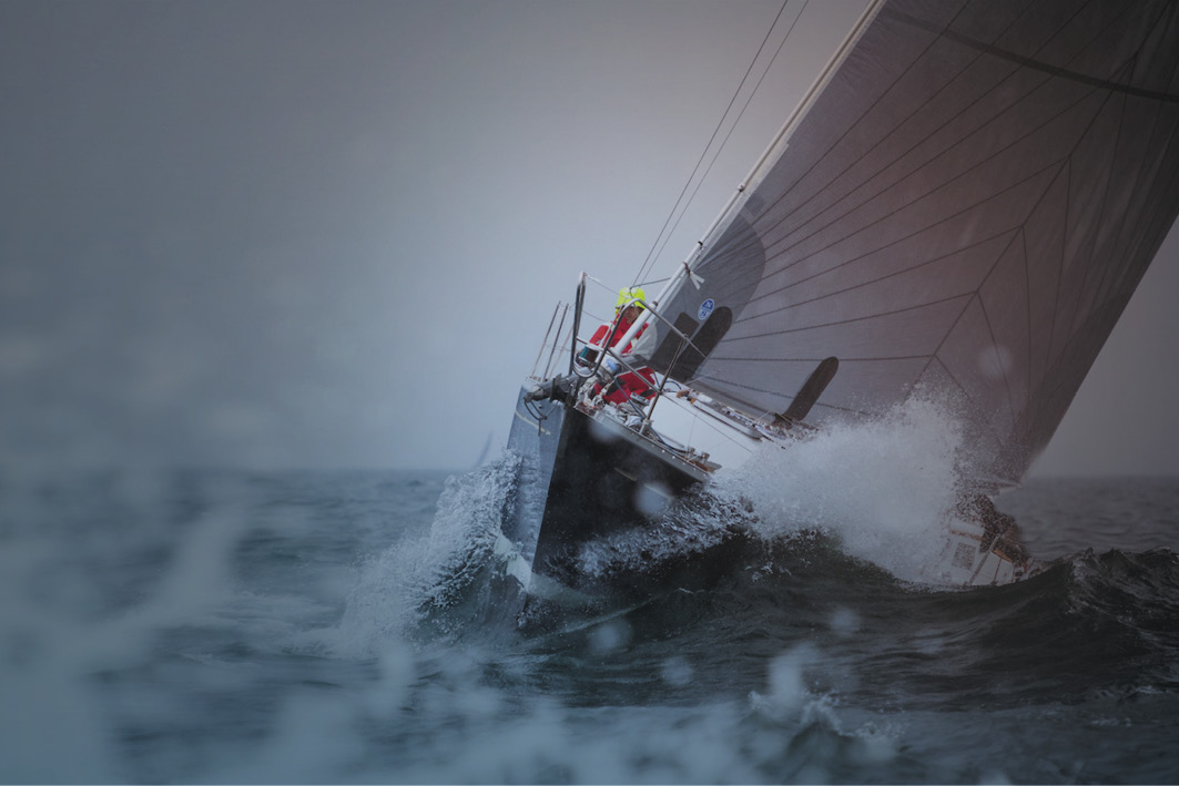 Sailing boat at sea in rough waters