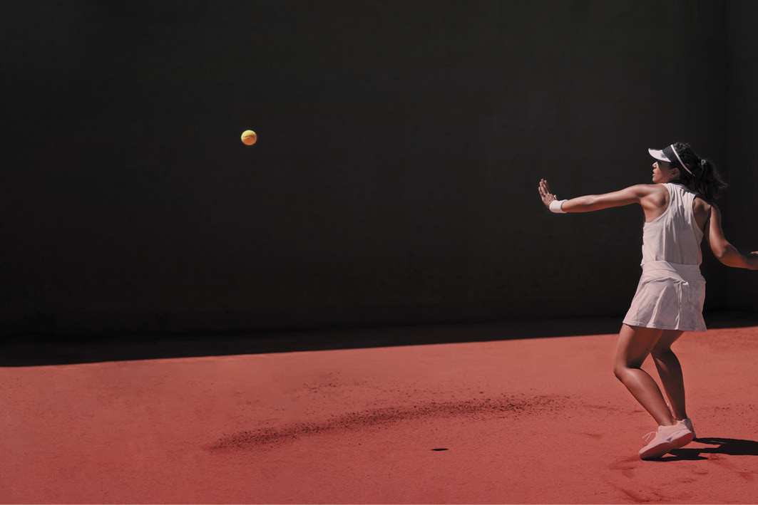 Woman playing tennis about to hit the ball