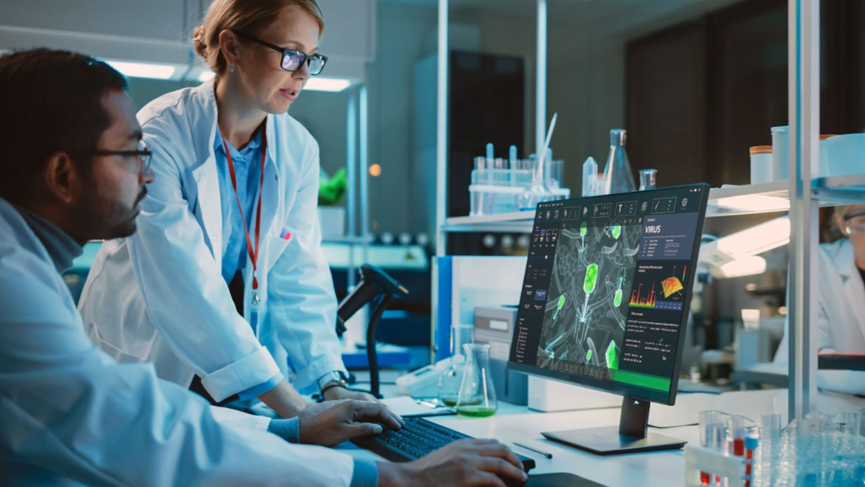 Man and woman looking at a computer screen in a lab