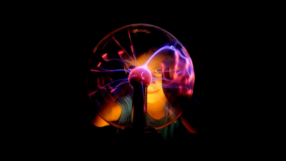 Child playing with a plasma sphere